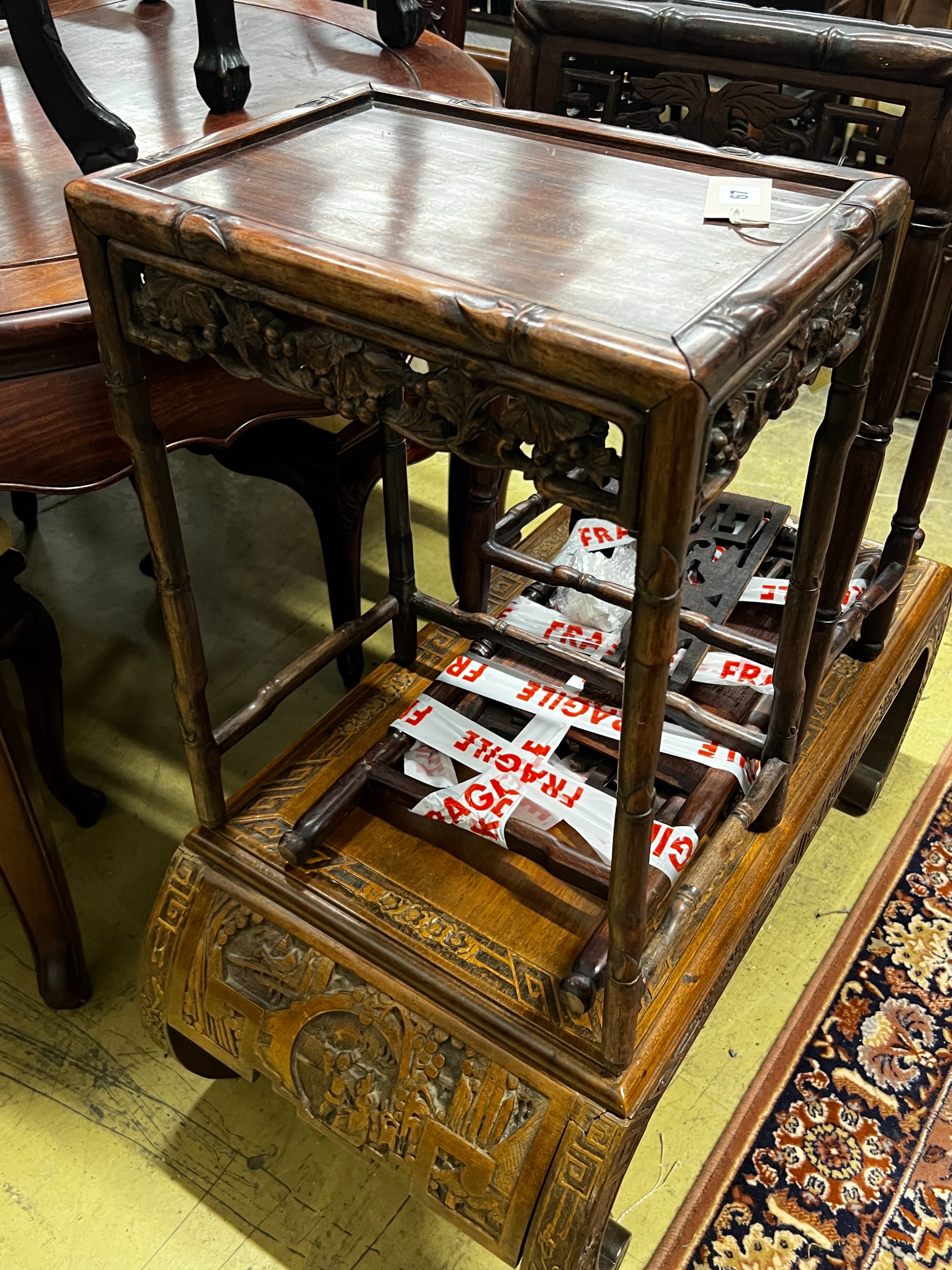 A Chinese carved hardwood low table, length 89cm, depth 43cm, height 36cm together with three Chinese carved hongmu occasional tables (one in need of extensive repair)